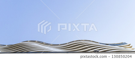 Facade of the modern building made in shape of the waves Facade of the modern building made in shape of the waves 130850204