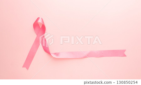 Breast Cancer Awareness Month in October banner. Pink ribbon awareness symbol for supporting breast cancer patient on pink background with copy space. Women's health care and medical. Breast Cancer Awareness Month in October banner. Pink ribbon awareness symbol for supporting breast cancer patient on pink background with copy space. Women's health care and medical. 130850254