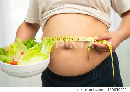Asian woman with fat belly big size overweight and obesity with healthy food. 130850321