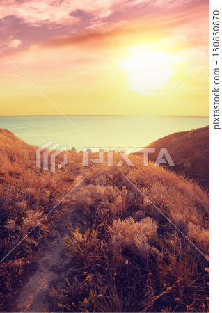 Seascape with clay steep coast. Seashore on a sunny day. Vertical image 130850870