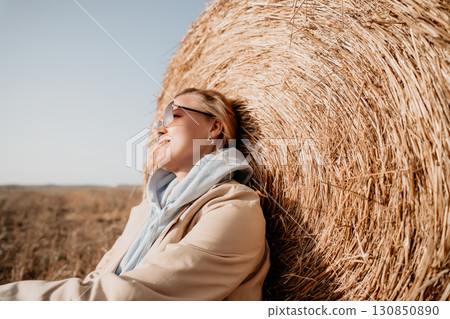 Relaxing Against a Hay Bale on a Sunny Day Relaxing Against a Hay Bale on a Sunny Day 130850890