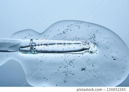A facial serum with microneedles and a pipette on a blue background. The texture. 130852265
