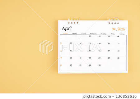 April 2026 desk calendar on yellow color background, position with copy space. 130852616
