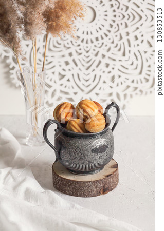 Russian traditional homemade cookies Nuts with condensed milk on an vintage jar on a wooden stand Russian traditional homemade cookies Nuts with condensed milk on an vintage jar on a wooden stand 130853513