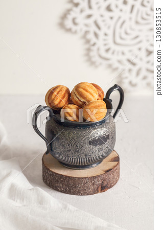 Russian traditional homemade cookies Nuts with condensed milk on an vintage jar on a wooden stand Russian traditional homemade cookies Nuts with condensed milk on an vintage jar on a wooden stand 130853515