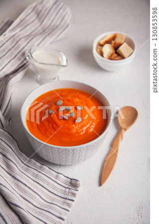 Pumpkin soup-puree with cream and seeds on a white background Pumpkin soup-puree with cream and seeds on a white background 130853598