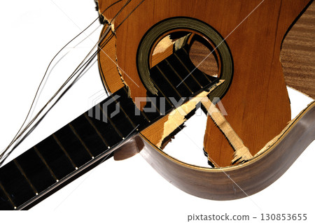 A broken smashed acousitic guitar music instrument on white background A broken smashed acousitic guitar music instrument on white background 130853655