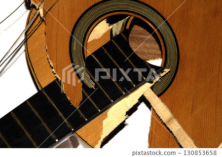 A broken smashed acousitic guitar music instrument on white background A broken smashed acousitic guitar music instrument on white background 130853658