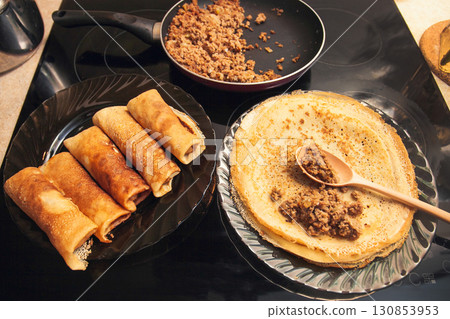 Cooking homemade Russian pancakes Bliny with meat on Shrovetide - Maslenitsa 130853953