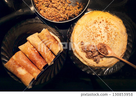 Cooking homemade Russian pancakes Bliny with meat on Shrovetide - Maslenitsa. Cooking at home 130853958