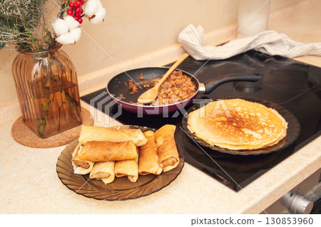 Cooking homemade Russian pancakes Bliny with meat on Shrovetide - Maslenitsa. Cooking at home Cooking homemade Russian pancakes Bliny with meat on Shrovetide - Maslenitsa. Cooking at home 130853960