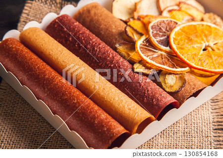 Sweet fruit snacks in a package - pastilles and dried fruit. 130854168