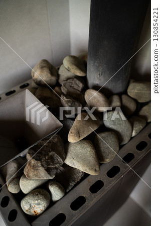 Vertical shot of sauna stones in heater for spa and wellness environment 130854221