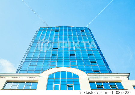 Part of the building with glazed windows against the sky Part of the building with glazed windows against the sky 130854225
