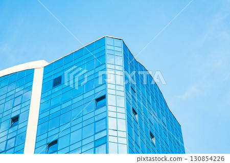 Part of the building with glazed windows against the sky Part of the building with glazed windows against the sky 130854226