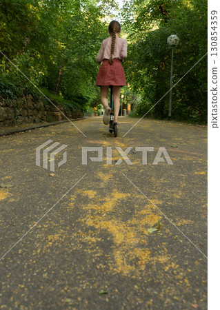 Girl on a scooter Girl on a scooter 130854359