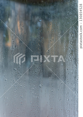 Closeup shot of a steamy window with water drops 130854528