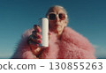 A cool grandma holding a tall soda can up to the camera.  130855263