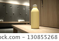 A modern gym locker room with a pastel yellow water bottle is placed neatly on the bench.  130855268