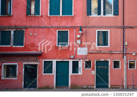 Colorful building facade with windows and doors Colorful building facade with windows and doors 130855297