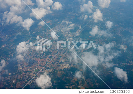 City landscape under clouds, view from airplane window City landscape under clouds, view from airplane window 130855303