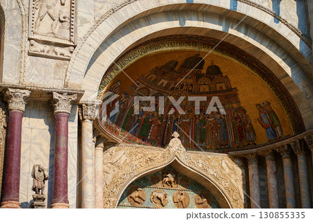 Historic church facade with colorful mosaic and marble columns in Venice 130855335