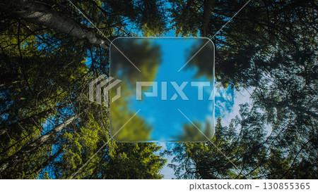 Futuristic glass frame floating in forest sky perspective with blurred digital effect Futuristic glass frame floating in forest sky perspective with blurred digital effect 130855365
