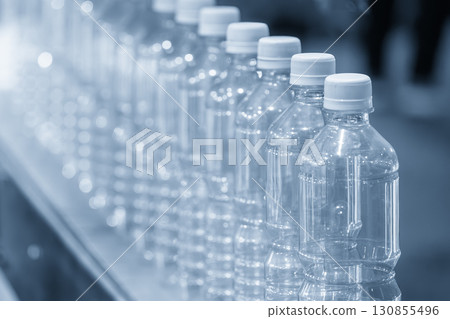 The  empty drinking water bottles  on the  conveyor belt for filling process in the blue scene. 130855496