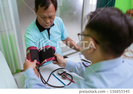 Health Check A Doctor is Measuring the Blood Pressure of a Patient Today 130855545