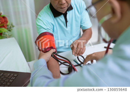 Health Checkup A Doctor is Measuring a Patients Blood Pressure Inside the Clinic 130855648