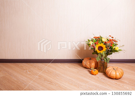 autumn still life on wooden background with bouquet of sunflowers, pumpkin, sweaters and persimmon on the floor autumn still life on wooden background with bouquet of sunflowers, pumpkin, sweaters and persimmon on the floor 130855692