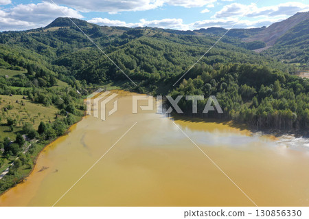 Patterns of acid mine drainage in decanting lake, nature pollution, aerial view 130856330