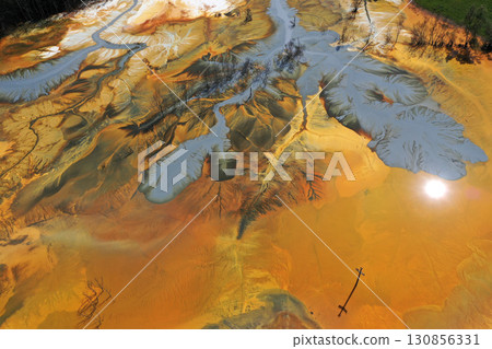 Patterns of acid mine drainage in decanting lake, nature pollution, aerial view Patterns of acid mine drainage in decanting lake, nature pollution, aerial view 130856331
