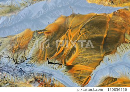 Patterns of acid mine drainage in decanting lake, nature pollution, aerial view 130856336