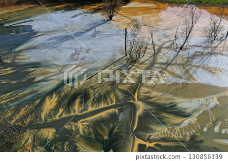 Patterns of acid mine drainage in decanting lake, nature pollution, aerial view Patterns of acid mine drainage in decanting lake, nature pollution, aerial view 130856339