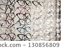 Many different stylish glasses on light grey background, flat lay 130856809