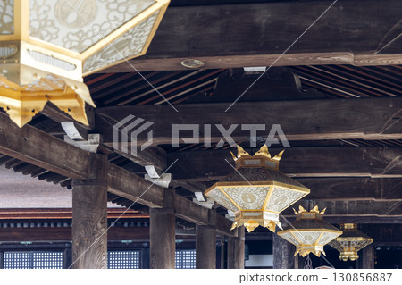Interior of Kiyomizu dera temple Kyoto Japan with wooden beams and ornate golden lanterns hanging 130856887