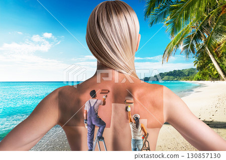 two people paint a tan on a woman's back 130857130