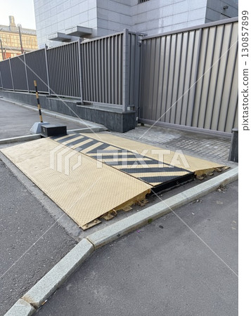 Automated car parking barrier in urban setting, emphasizing modern infrastructure design 130857899