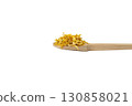 Dried Calendula or Marigold petals on wooden spoon isolated on white background. 130858021