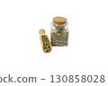 passion flower herb in latin - passiflora incarnata in wooden scoop and glass jar isolated on white background. Herbs. Alternative medicine. 130858028