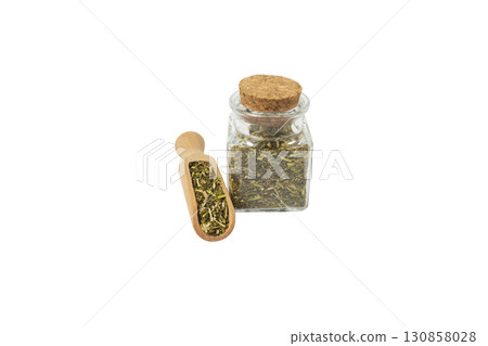 passion flower herb in latin - passiflora incarnata in wooden scoop and glass jar isolated on white background. Herbs. Alternative medicine. 130858028