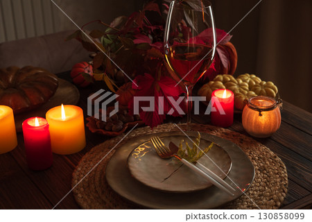 Autumn Table Setting with Pumpkins, Candles and Leaf Decor 130858099