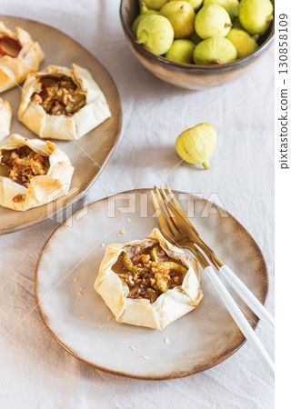 Fig Galette on Ceramic Plate with Fresh Figs and Rustic Background 130858109