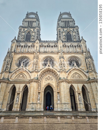 The magnificent Flamboyant Gothic Orleans Cathedral of the Holy Cross on a rainy day. French basilique Sainte-Croix ornate with twin towers and a large rose windows The magnificent Flamboyant Gothic Orleans Cathedral of the Holy Cross on a rainy day. French basilique Sainte-Croix ornate with twin towers and a large rose windows 130858195
