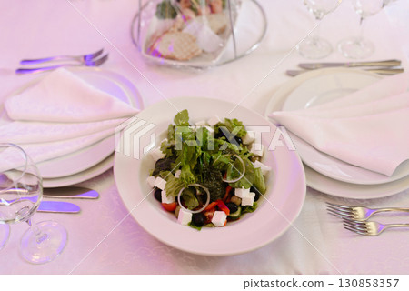 Fresh Greek Salad With Feta Cheese On Elegant Table 130858357