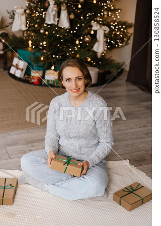 Woman Smiling With Christmas Gift Box Woman Smiling With Christmas Gift Box 130858524