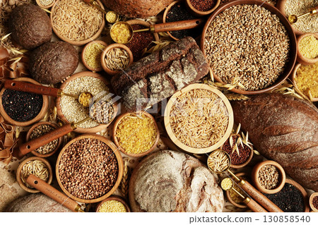 Whole grains concept background. Colorful mix of grain varieties: oat and wheat, rice and millet, buckwheat and barley, quinoa and polenta. Food ingridients for healthy diet. Selective focus 130858540
