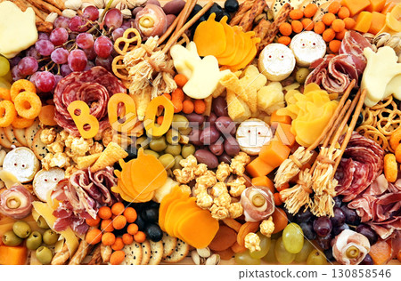 Halloween charcuterie board fun food mix: ghosts, mummies, pumpkins, eyes, brooms. Party spooky salty snacks Halloween charcuterie board fun food mix: ghosts, mummies, pumpkins, eyes, brooms. Party spooky salty snacks 130858546