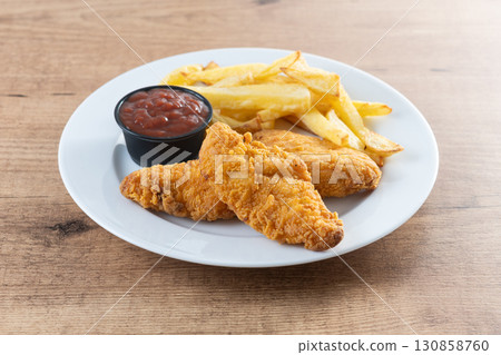 Crispy fried chicken tenders with french fries 130858760